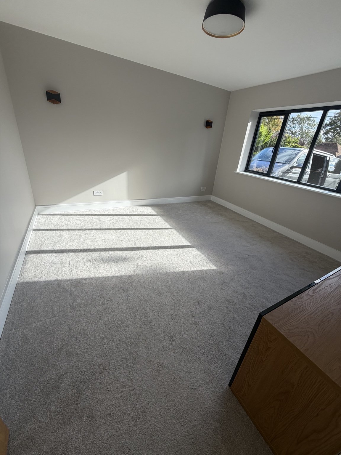 Finished bedroom with carefully decorated walls and skirting