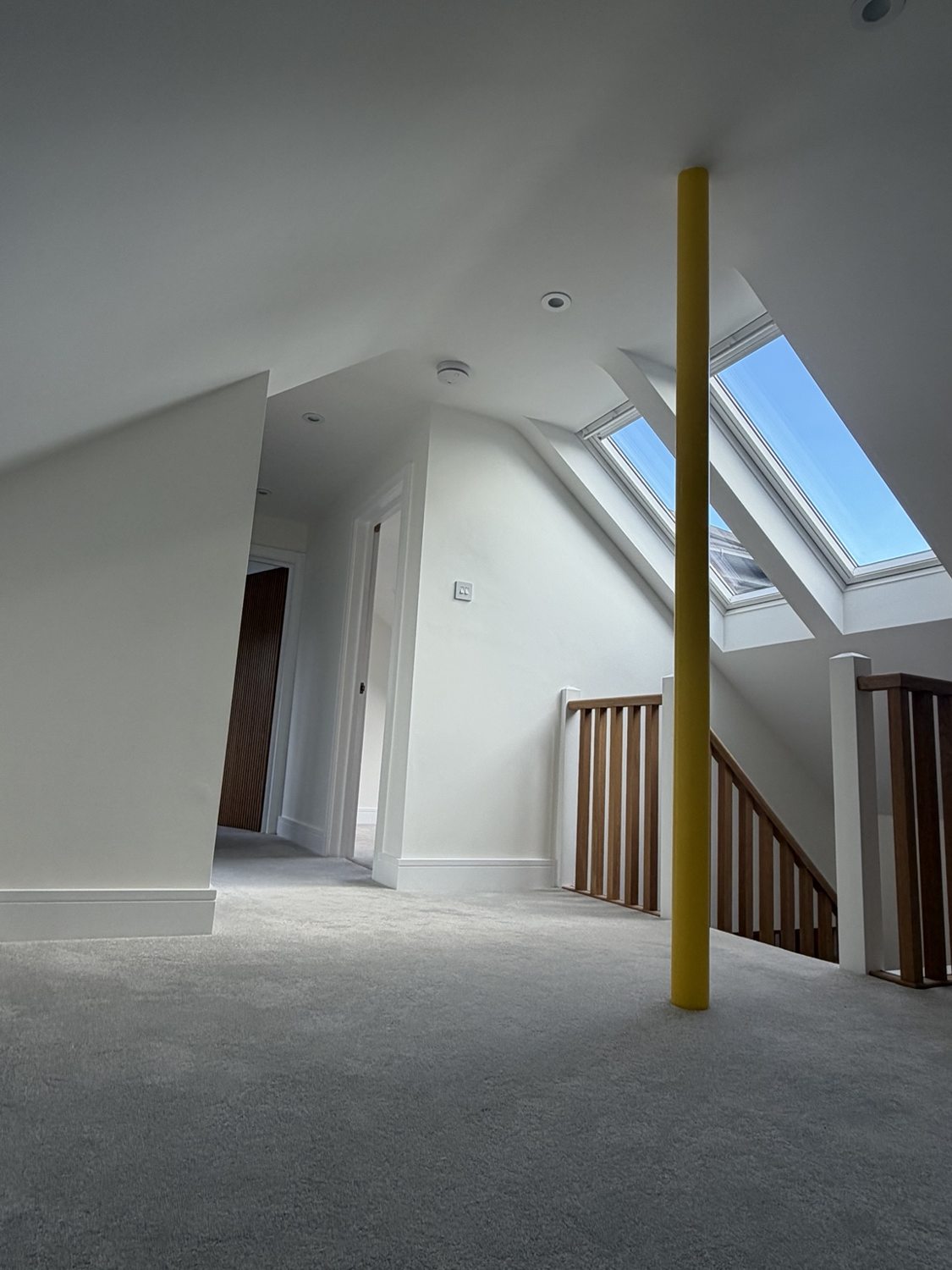 Upstairs hallway and landing with freshly decorated walls, ceilings and woodwork