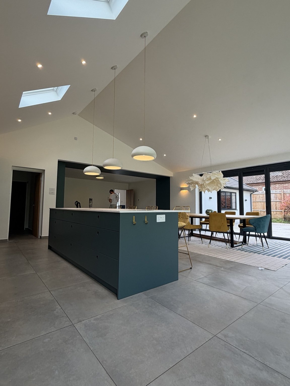 Open-plan kitchen and dining area with professionally finished ceilings and walls