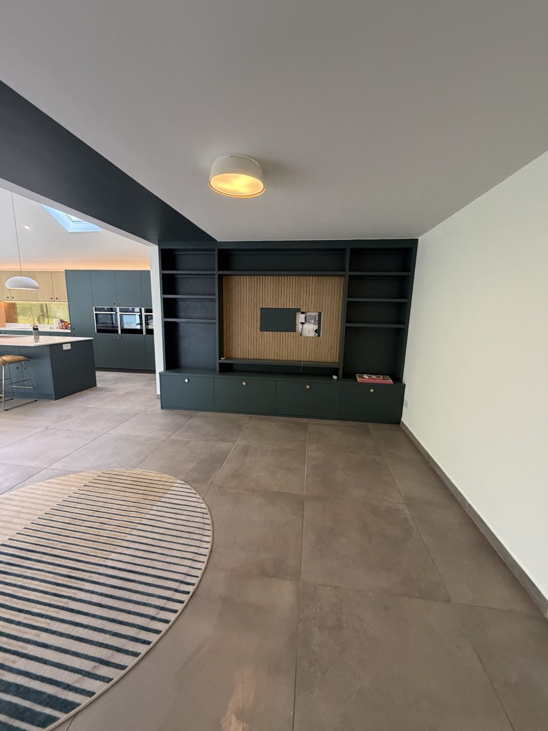 Decorated living area alongside the existing fitted media wall