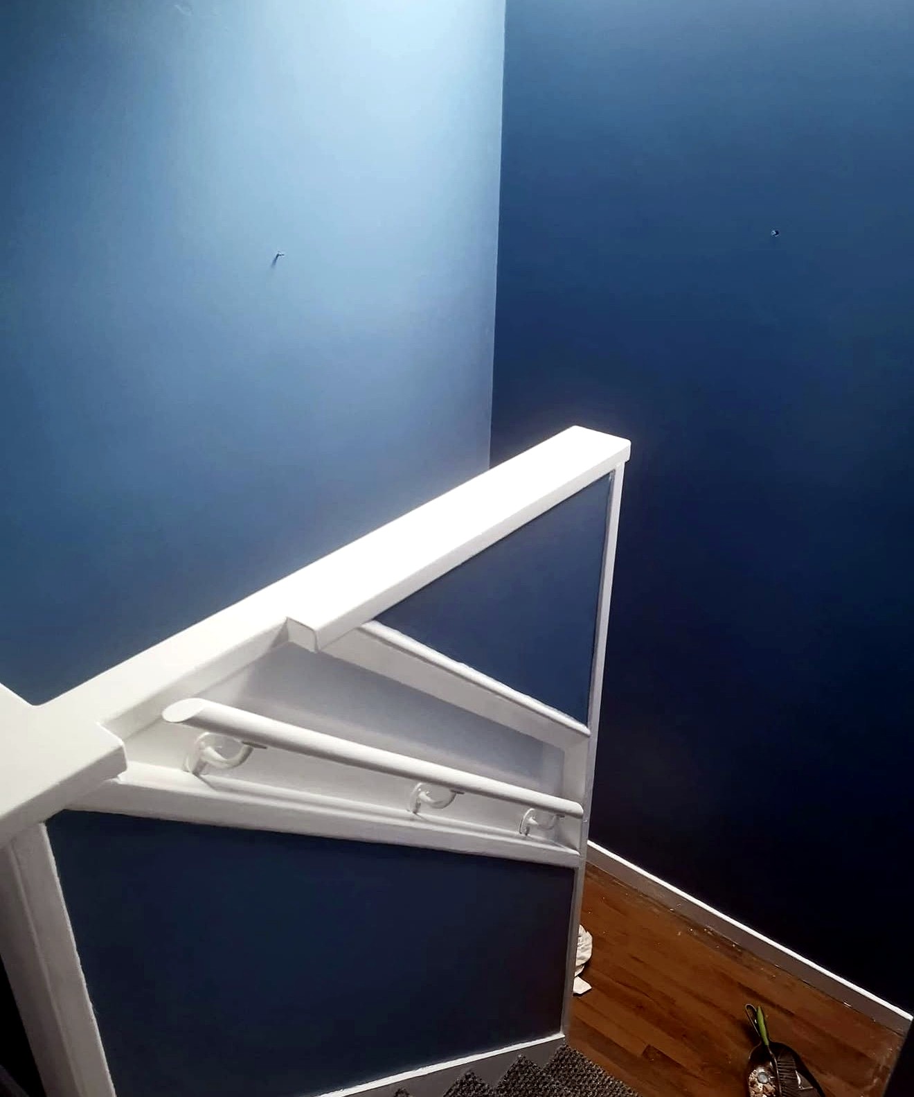 Blue stairwell with crisp white woodwork