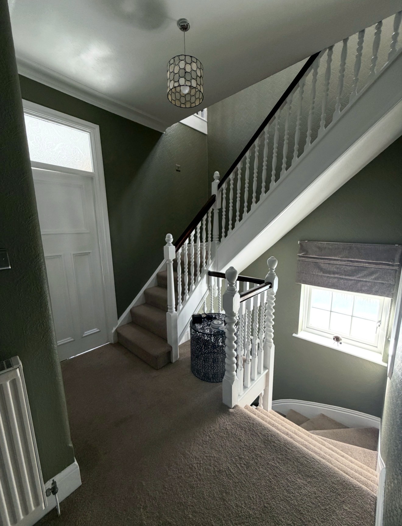 Green staircase and landing with white balustrades