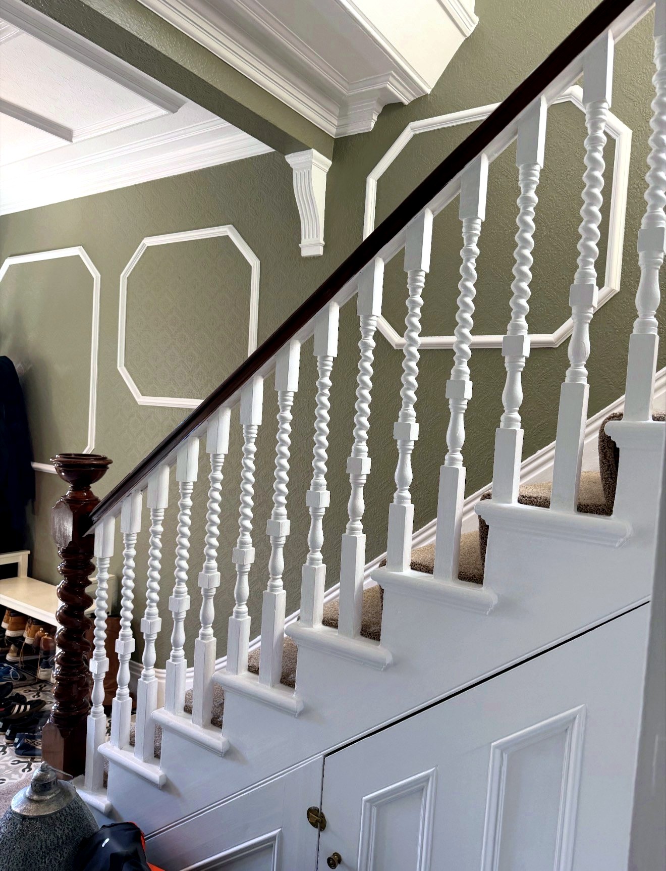 Crisp white stair spindles and detailed wall finish