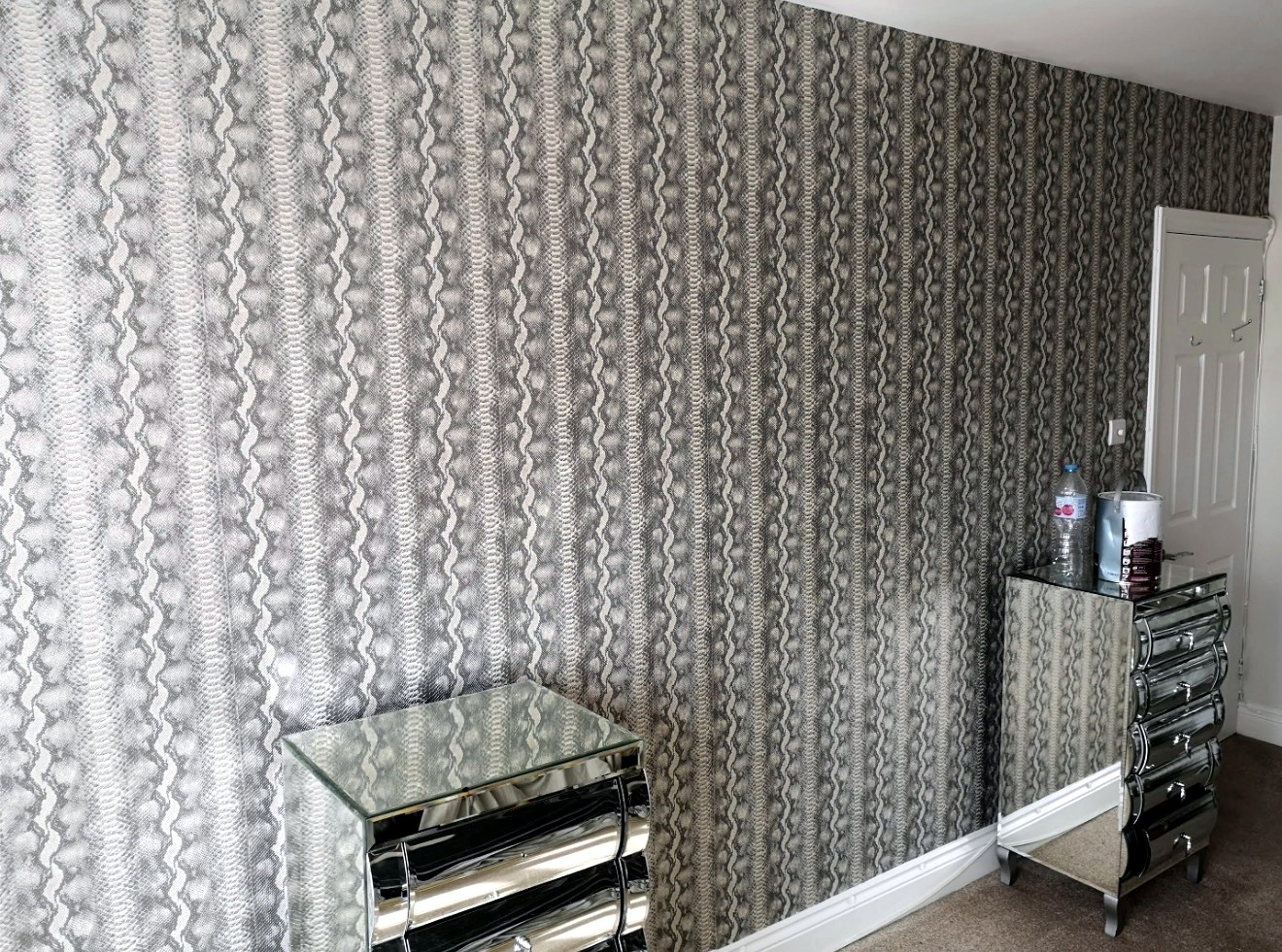 Grey patterned wallpaper installation