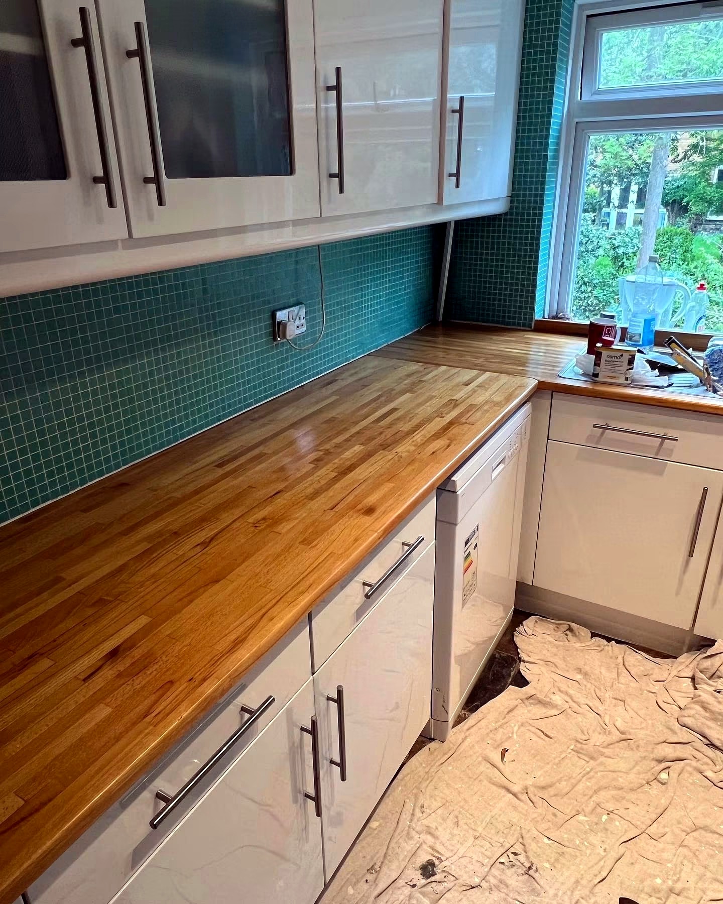 Restored timber worktop with turquoise splashback